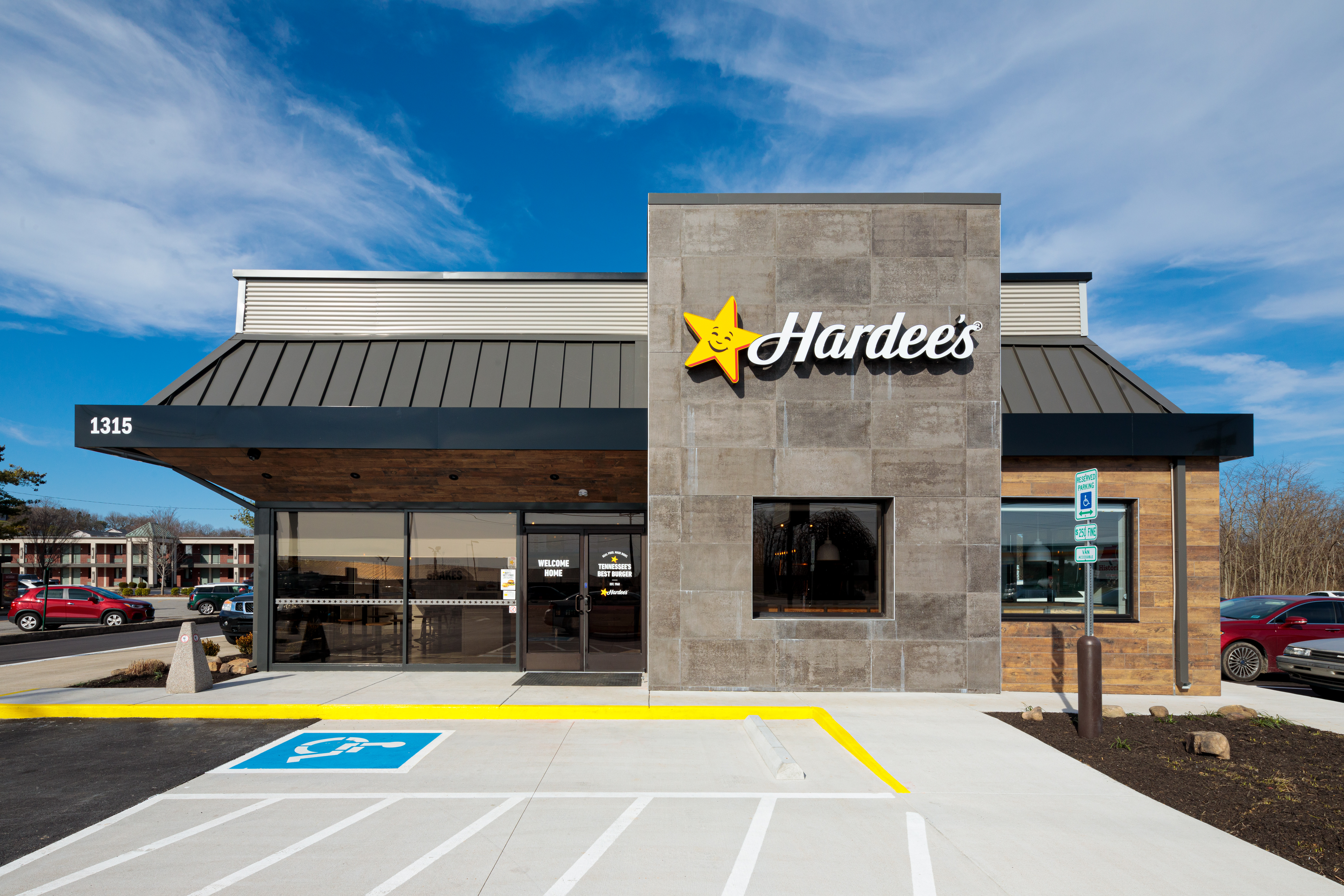 Hardee's restaurant storefront with parking lot in front